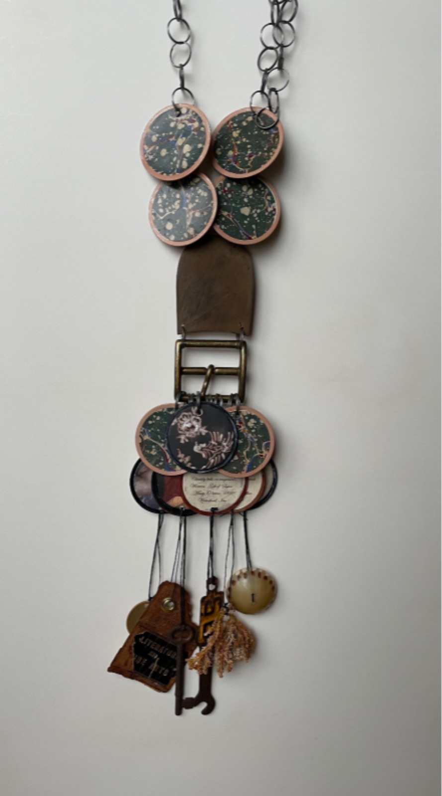 Douglas Dawson Tags, book cover pages, shoe sole, brass belt buckle, other found materials, organic and artificial 2021